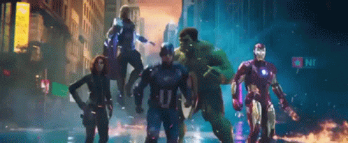 A Group Of Avengers Standing On A City Street GIF