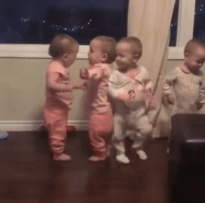 A Group Of Babies Are Dancing Together In A Room GIF