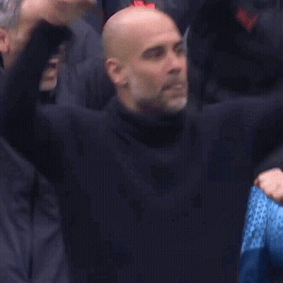 A Group Of Bald Men Are Sitting In A Stadium With Their Hands In The Air . GIF