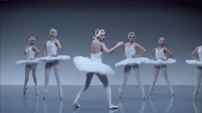 A Group Of Ballerinas Are Dancing In A Row On A Gray Background . GIF