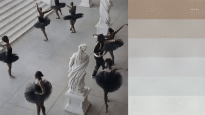A Group Of Ballerinas Are Dancing In Front Of A Statue Of A Woman GIF