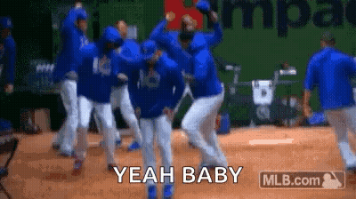 A Group Of Baseball Players Are Dancing On A Field And They Are Saying Yeah Baby . GIF