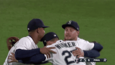 A Group Of Baseball Players Are Hugging Each Other And The Score Is T2s6 GIF