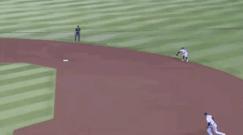 A Group Of Baseball Players Are Playing A Game Of Baseball On A Baseball Field . GIF