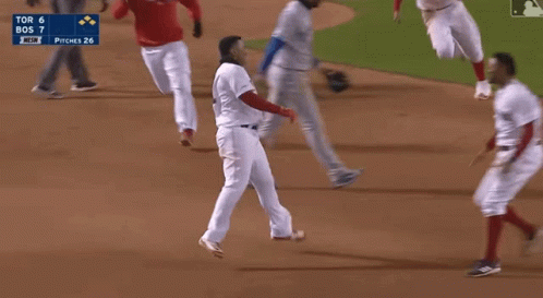 A Group Of Baseball Players Are Running On A Field With The Scoreboard Showing Tor 6 Bos 7 GIF