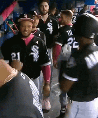 A Group Of Baseball Players Are Standing In A Dugout And One Of Them Has The Number 21 On His Jersey GIF