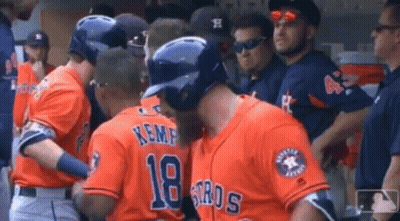 A Group Of Baseball Players Are Standing In The Dugout . GIF