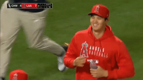 A Group Of Baseball Players Are Standing On A Field During A Game . GIF