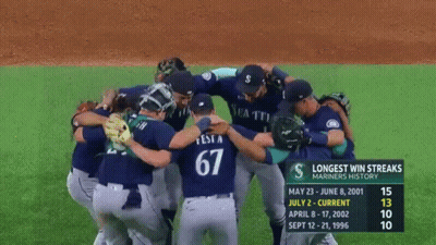 A Group Of Baseball Players Huddled Together With The Number 67 On The Back Of Their Jersey GIF