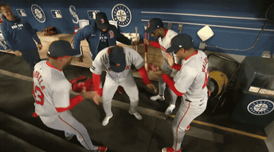 A Group Of Baseball Players In A Dugout One Of Whom Is Wearing A Jersey With The Number 33 On It GIF