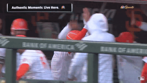 A Group Of Baseball Players In A Dugout With The Words Authentic Moments Live Here GIF