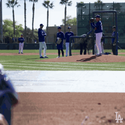 A Group Of Baseball Players On A Field With The La Logo In The Background GIF