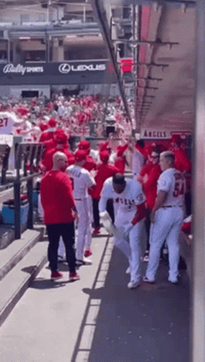 A Group Of Baseball Players Standing In A Dugout With A Sign That Says Lexus On It GIF