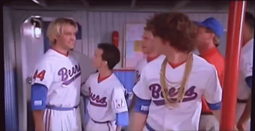 A Group Of Baseball Players Standing Next To Each Other In A Locker Room . GIF