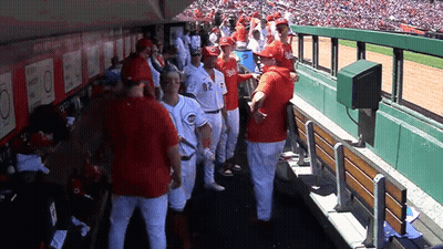 A Group Of Baseball Players Wearing Red Uniforms With The Number 82 On The Back GIF