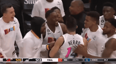 A Group Of Basketball Players Are Gathered Around A Player With The Name Herro On The Back Of His Jersey GIF