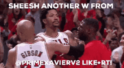 A Group Of Basketball Players Are Hugging Each Other In Front Of A Crowd GIF