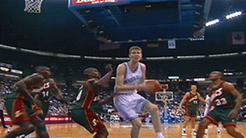 A Group Of Basketball Players Are Playing A Game And One Of Them Has The Number 33 On His Shorts GIF