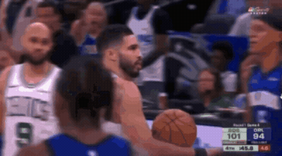 A Group Of Basketball Players Are Playing A Game And One Of Them Is Holding A Basketball . GIF