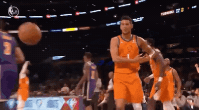 A Group Of Basketball Players Are Playing A Game In A Stadium . GIF