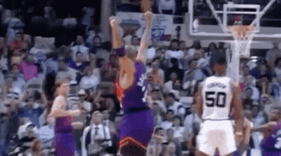A Group Of Basketball Players Are Playing A Game Of Basketball In A Stadium . GIF