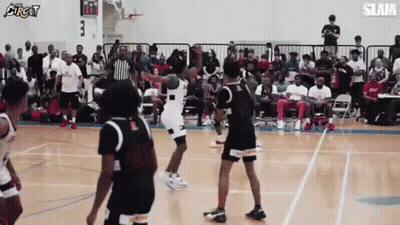 A Group Of Basketball Players Are Playing A Game Of Basketball On A Court . GIF