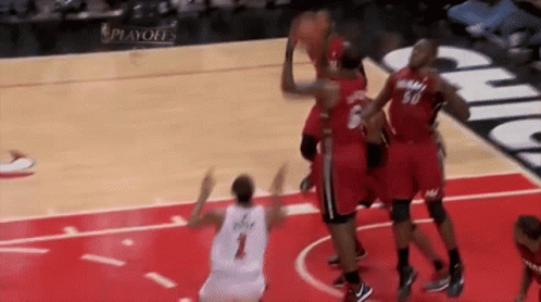 A Group Of Basketball Players Are Playing A Game Of Basketball On A Court . GIF