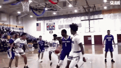 A Group Of Basketball Players Are Playing A Game Of Basketball On A Court . GIF