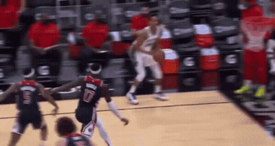 A Group Of Basketball Players Are Playing A Game Of Basketball On A Court In Front Of A Crowd . GIF