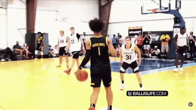 A Group Of Basketball Players Are Playing A Game Of Basketball On A Court . GIF