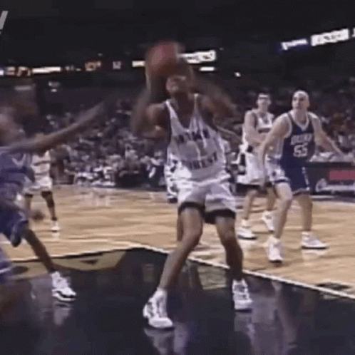 A Group Of Basketball Players Are Playing A Game On A Court . One Of The Players Has The Number 53 On His Jersey . GIF