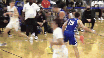 A Group Of Basketball Players Are Playing A Game On A Court . One Of The Players Is Wearing The Number 15 Jersey . GIF