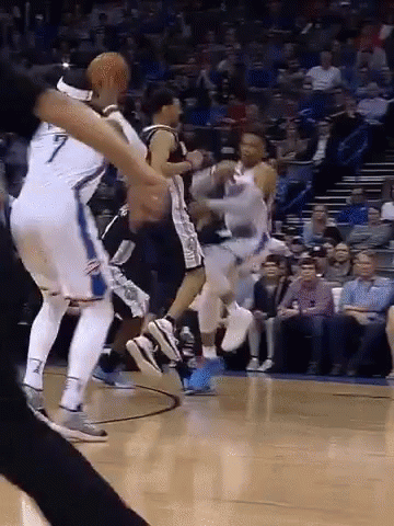 A Group Of Basketball Players Are Playing A Game On A Court . GIF