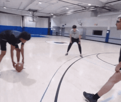 A Group Of Basketball Players Are Playing A Game On A Court With A Logo On The Wall That Says ' A ' GIF