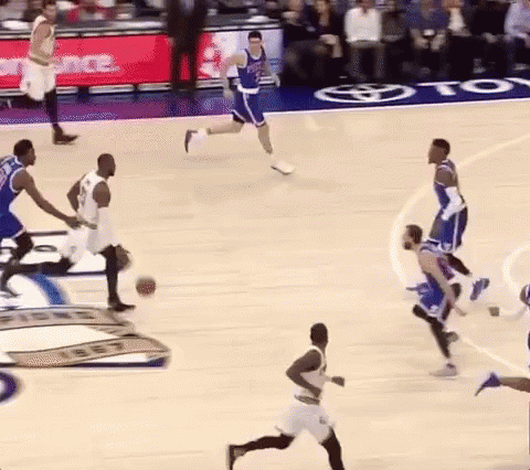 A Group Of Basketball Players Are Playing A Game On A Court With A Toyota Ad In The Background . GIF