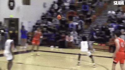 A Group Of Basketball Players Are Playing Basketball On A Court . GIF