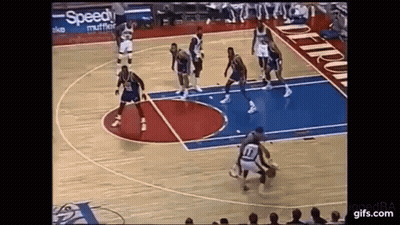 A Group Of Basketball Players Are Playing Basketball On A Court . GIF