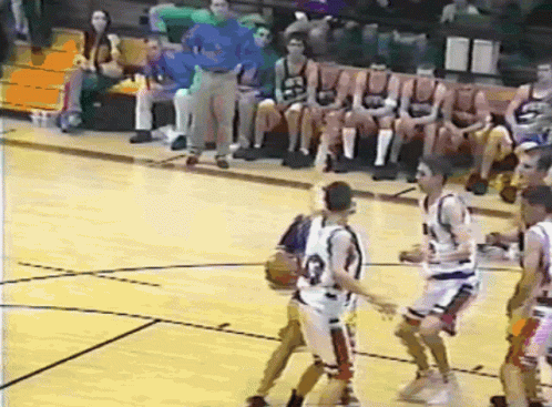 A Group Of Basketball Players Are Playing On A Court And One Of Them Is Wearing A Jersey With The Number 23 On It GIF