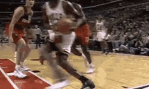 A Group Of Basketball Players Are Playing On A Court . GIF