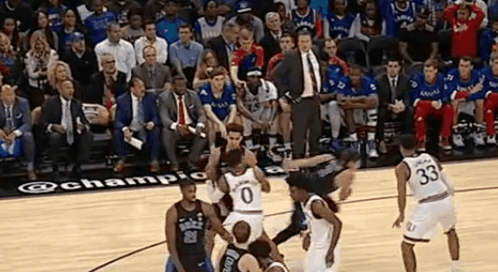 A Group Of Basketball Players Are Playing On A Court With A Crowd Watching GIF