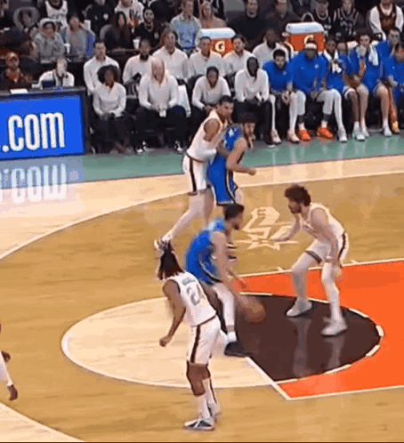 A Group Of Basketball Players Are Playing On A Court With A Gatorade Sign Behind Them GIF