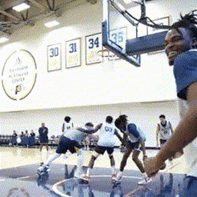 A Group Of Basketball Players Are Playing On A Court With Numbers 30 31 34 And 35 On The Wall Behind Them GIF