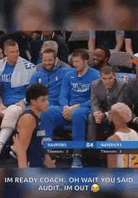 A Group Of Basketball Players Are Sitting In A Stadium Watching A Game . GIF