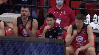 A Group Of Basketball Players Are Sitting In The Stands Wearing Red And Black Jerseys With The Letter C On The Front GIF