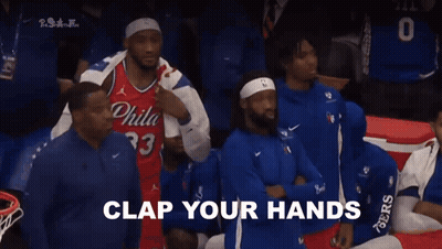 A Group Of Basketball Players Are Sitting In The Stands With The Words " For Philadelphia " Written In White GIF