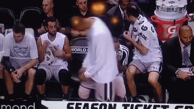 A Group Of Basketball Players Are Sitting On A Bench With A Sign That Says Season Ticket On It GIF