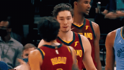 A Group Of Basketball Players Are Standing On A Court . GIF