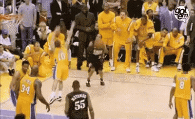 A Group Of Basketball Players Are Standing On A Court . GIF