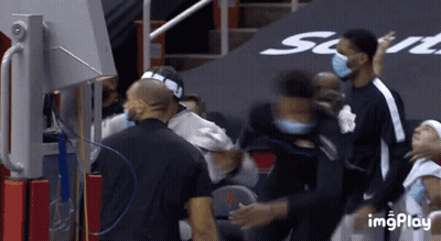 A Group Of Basketball Players Wearing Face Masks Are Standing In A Stadium GIF