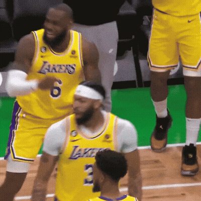 A Group Of Basketball Players Wearing Yellow Jerseys With Lakers On Them GIF